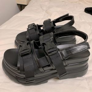 Chunky black platform sandals with buckles